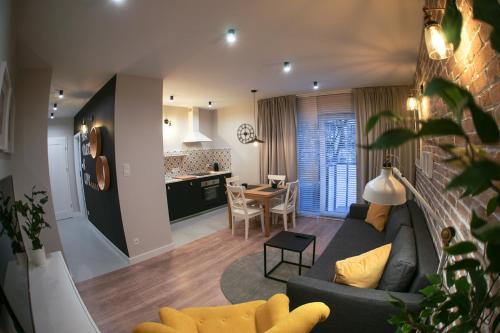 a living room with a couch and a table at Barson Apartments in Warsaw