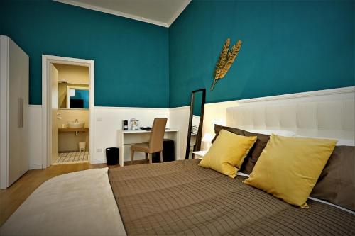 a bedroom with a bed with a blue wall at romantica guest house in Rome