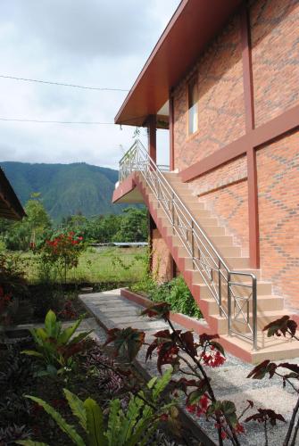 a staircase on the side of a brick building at Toba Village Inn in Tuk Tuk