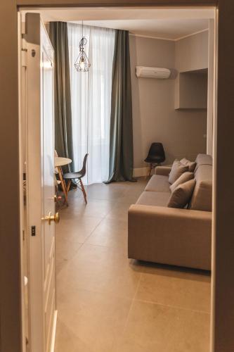 a living room with a couch and a dining room at Relais Della Porta in Naples