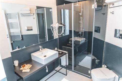 a bathroom with a sink and a shower at Relais Della Porta in Naples