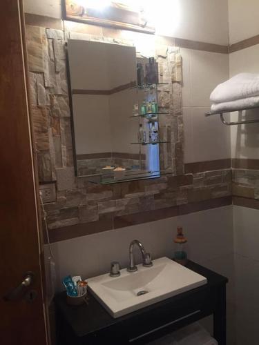 a bathroom with a sink and a mirror at Altos de Obligado in Vuelta de Obligado