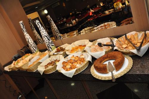 a buffet table filled with different types of food at Crystal Plaza Hotel in Goiânia