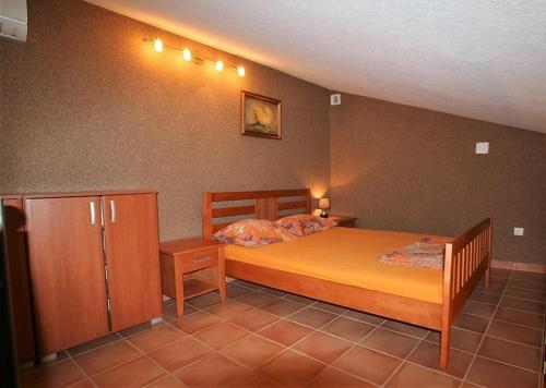 a bedroom with a bed and a cabinet in it at House on the beach in Kotor
