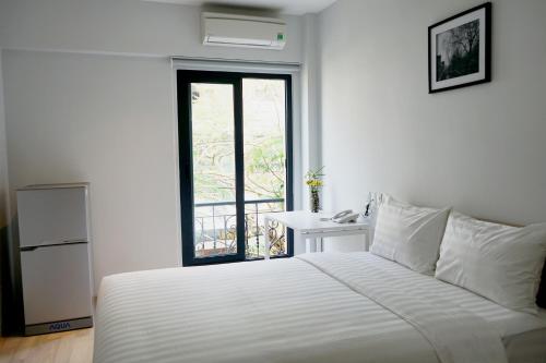 Кровать или кровати в номере La Cigale Residence