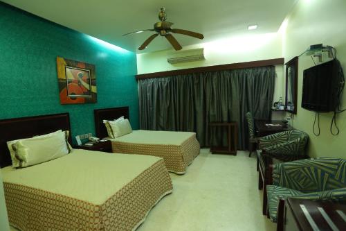 Ένα ή περισσότερα κρεβάτια σε δωμάτιο στο Golden Orchid - Kolkata