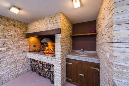 a brick oven in a kitchen with a sink at Little Dream in Poljana
