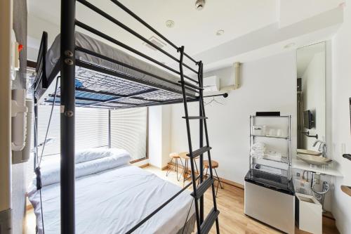 a bedroom with a bunk bed and a kitchen at Ya Do! KYOTO OKAZAKI in Kyoto