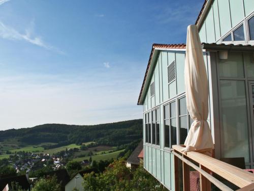 a building with a closed umbrella on the side of it at Berggasthof Hotel Igelwirt in Schnaittach