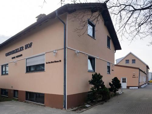 a building with a sign on the side of it at Hotel-Residenz Oberurseler Hof in Oberursel