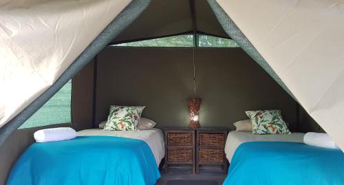 Un pat sau paturi într-o cameră la Kingfisher Bush Lodge