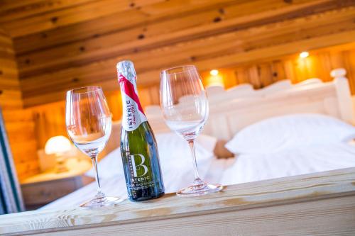 two wine glasses and a bottle of champagne on a table at Penzion Berc in Bled