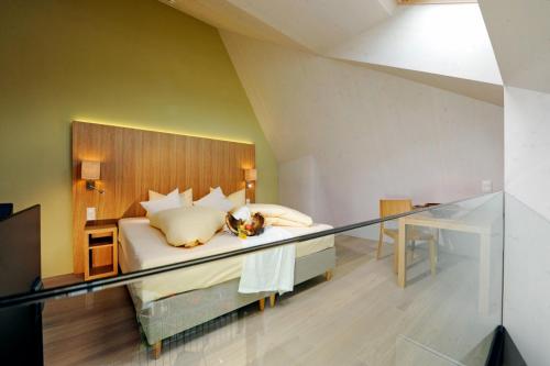 a bedroom with a bed with a glass railing at derNeuwirt in Schwendau