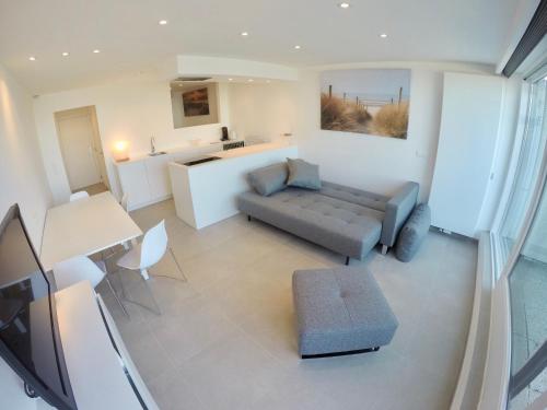 a living room with a couch and a table at Seanest - North Sea Stays in De Haan