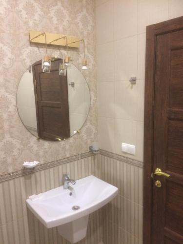 a bathroom with a sink and a mirror at Hotel Grant in Kharkiv