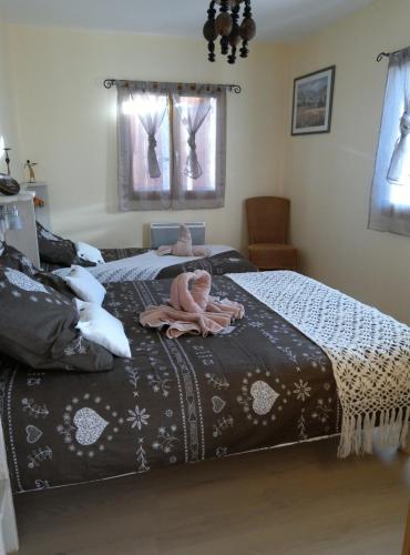 a bedroom with two beds with dolls on them at L'enchanteur in Saint-Jurs
