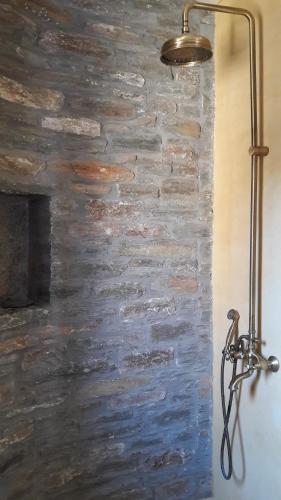 a lamp against a stone wall in a room at Bioclimatic stone built villa in Kastrianí