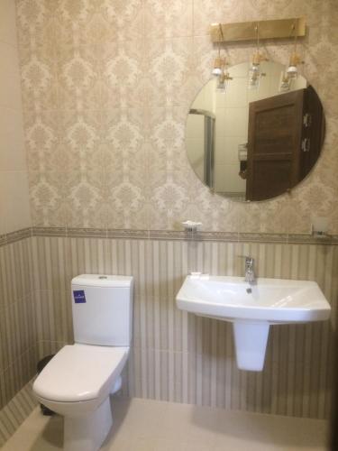a bathroom with a toilet and a sink at Hotel Grant in Kharkiv