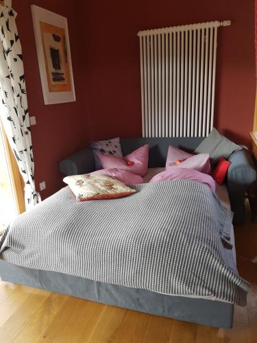 a bed with pillows on it in a bedroom at Holzmichel in Friedrichroda
