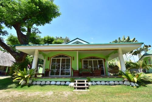 a green house with a roof on top of it at Greenland Residence House in Zamboanguita