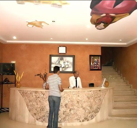 a man standing at a bar in a building at Hotel Porte Atlas in Imouzzer Kandar