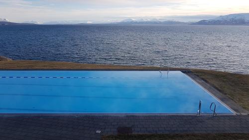 a swimming pool with a view of the water at The Viking Country Club in Hjalteyri