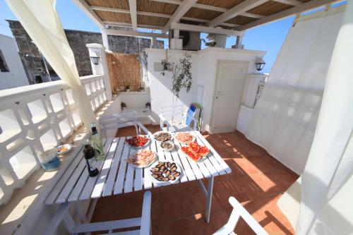 a balcony with a table with food and a bottle of wine at Casa Vacanze Bel sole in Monopoli