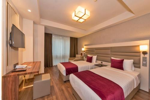 Ένα ή περισσότερα κρεβάτια σε δωμάτιο στο Golden Royal Hotel & SPA