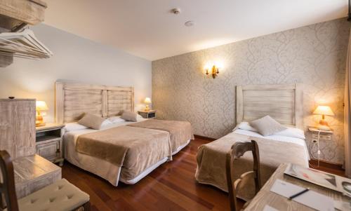 Ein Bett oder Betten in einem Zimmer der Unterkunft Hotel Alda Vía León