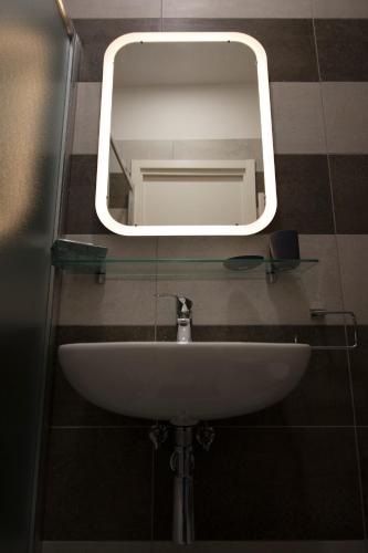 a bathroom sink with a mirror on a wall at Albergo Felice in Sottomarina