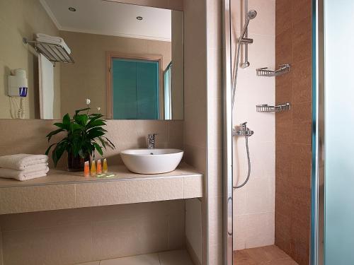a bathroom with a sink and a shower at Eleftheria Hotel in Agia Marina Nea Kydonias