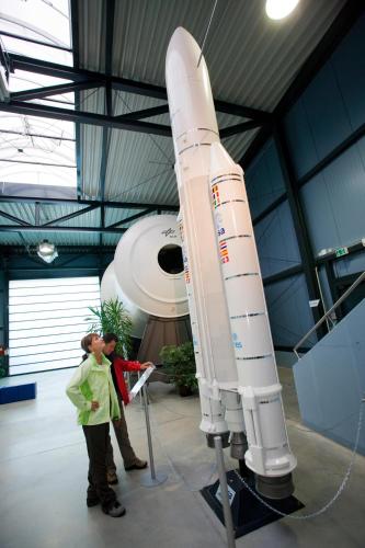 a woman is standing next to a rocket in a museum at Ferienhaus Nadine 2023 komplett saniert in Bad Brambach