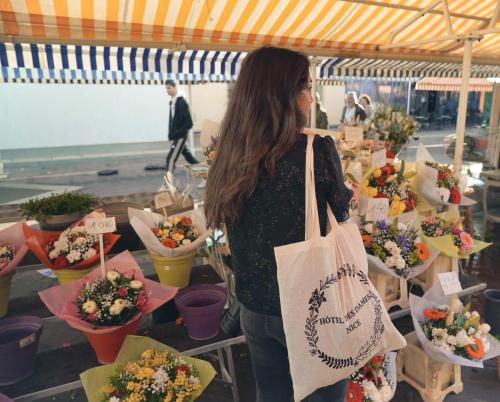 a woman standing in front of a display of flowers at Hotel des Dames in Nice