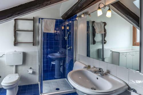 a bathroom with a sink and a toilet and a shower at Hotel La Fenice et Des Artistes in Venice