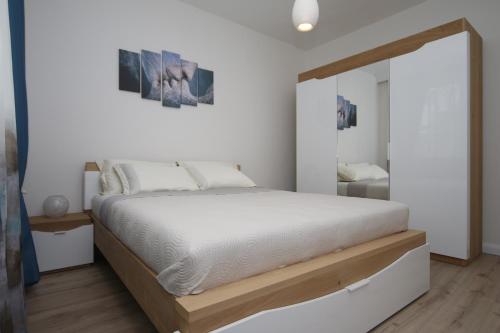 a bedroom with a large bed and a mirror at M&N Central Apartment in Plovdiv