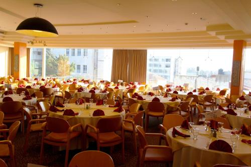 a large banquet hall with tables and chairs at Ambassador Hotel in Jerusalem