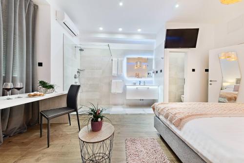 a hotel room with a bed and a bathroom at INFINITY CENTAR Zagreb in Zagreb