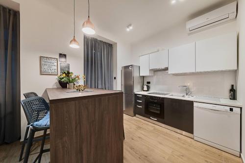 a kitchen with a island in the middle of it at INFINITY CENTAR Zagreb in Zagreb