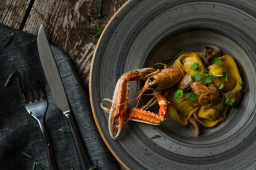 a plate of food with a lobster on a table at Hotel Senia - Onar Hotels Collection in Naousa