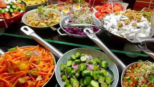 a buffet of different types of food in bowls at Ambassador Hotel in Jerusalem