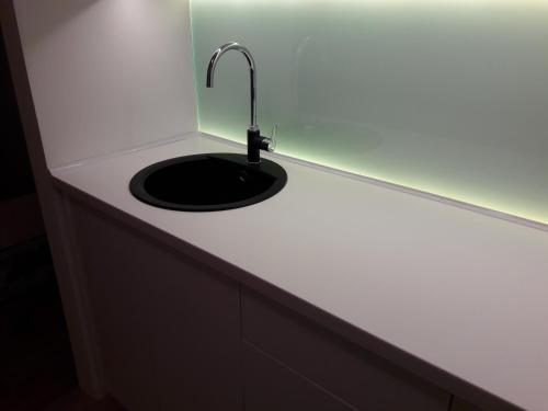 a sink with a faucet on top of a counter at Apartman Senjak in Pirot