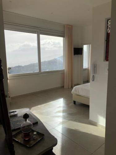 a bedroom with a bed and a large window at Sciala' in Taormina