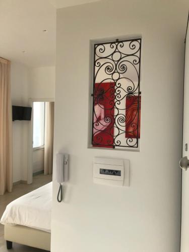a room with a bed and a picture on the wall at Sciala' in Taormina