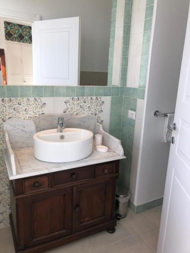 a bathroom with a sink and a mirror at Sciala' in Taormina