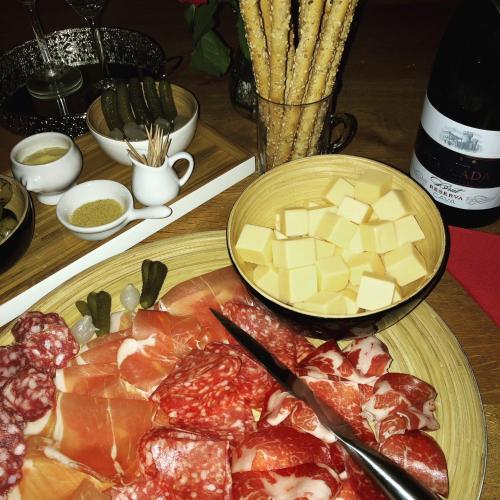 a plate of food with meat and cheese on a table at Bed & Breakfast Het Zilte Zand - luxe ontbijt - gratis parking - Westende Middelkerke in Middelkerke