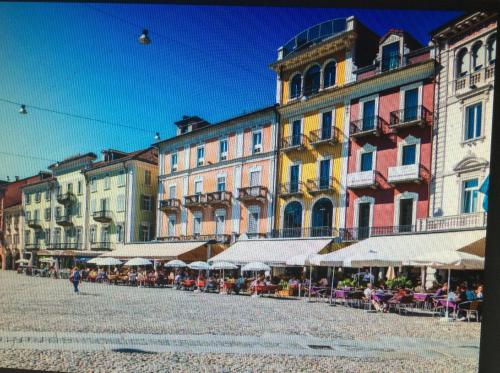 a group of buildings with tables and chairs in a street at Casa Sot Gesa in Verscio