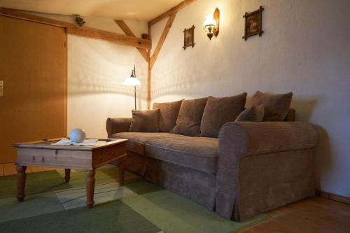 a living room with a couch and a table at Ferienwohnung Buchholz in Warnitz