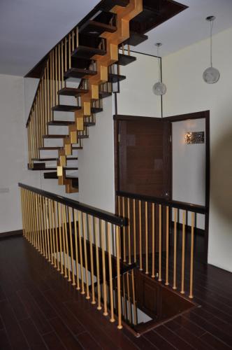 a staircase in a building with wooden railings at Arcadia Palace Apartments with Sea View in Odesa