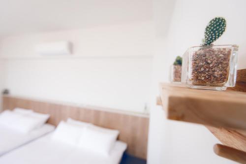 a room with two beds and a cactus on a shelf at snoozinn in Huxi