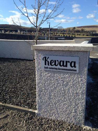 a sign for kevlar sitting on the side of a road at Kevara Self-Catering in Finstown